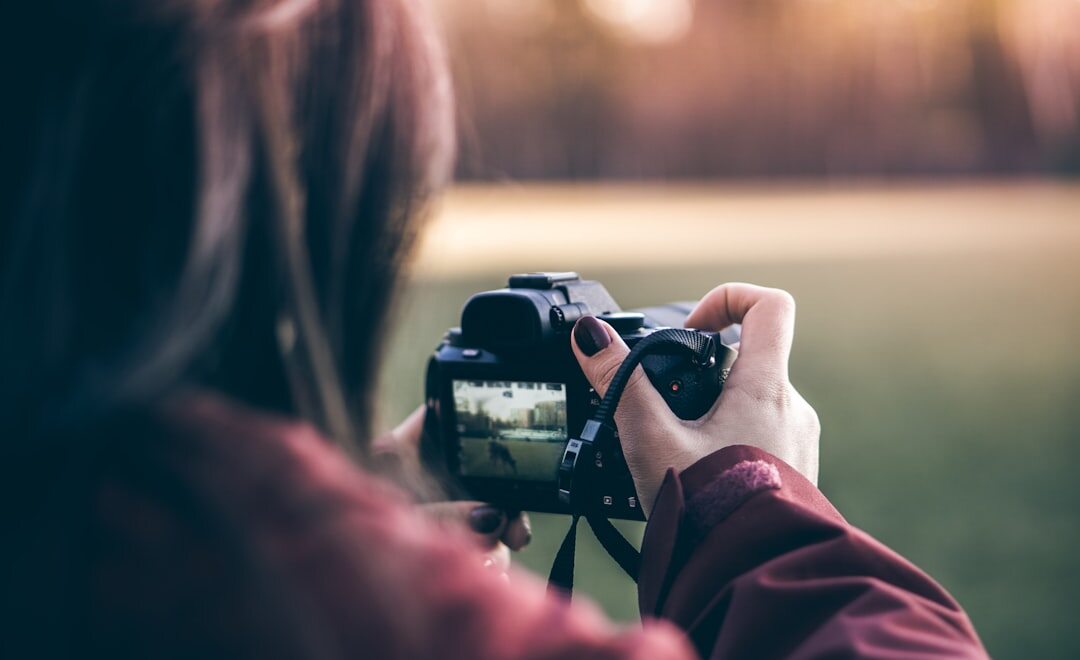 Documentary filmmaker shooting footage on location outdoors